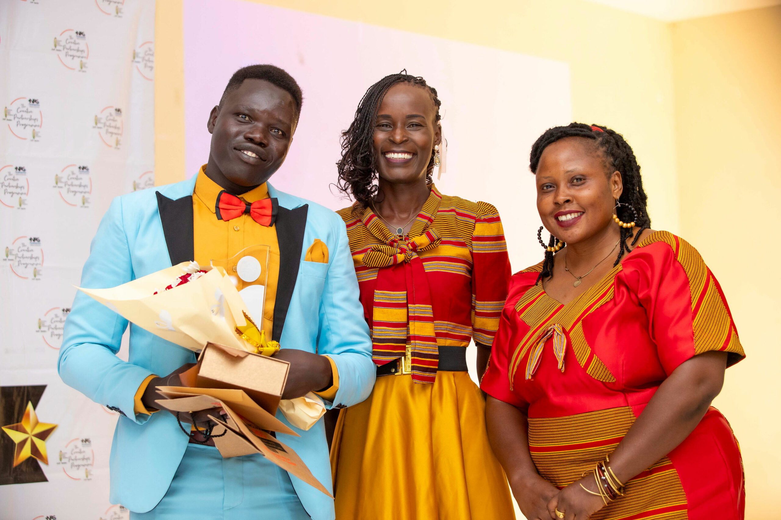 L-R: Winner Charles Owilla Kinyera, Catherine Laker, Margreth Achiro